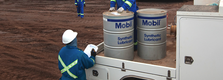 Workers Unloading Synthetic Oil Barrels
